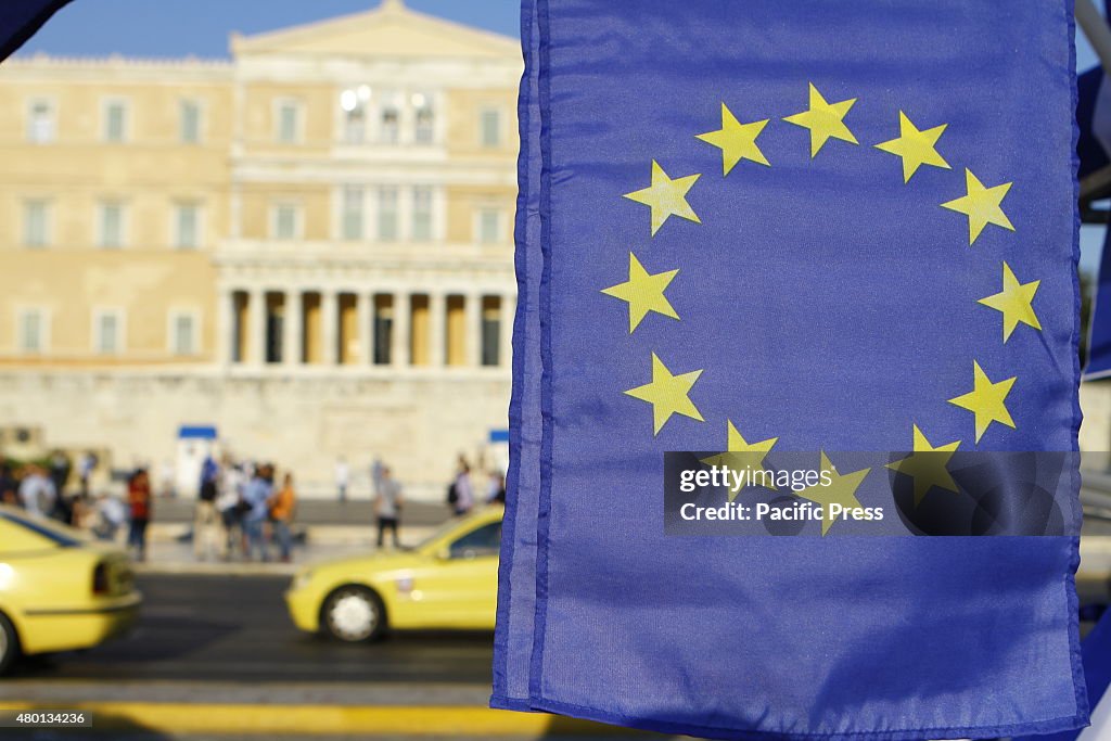 A European flag is pictured with the Greek Parliament in the...