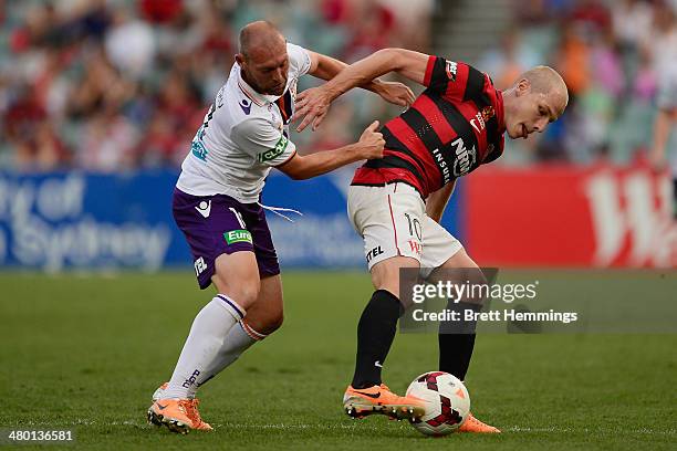 Aaron Mooy of the Wanderers is tackled by Steven McGarry of Perth during the round 24 A-League match between the Western Sydney Wanderers and Perth...