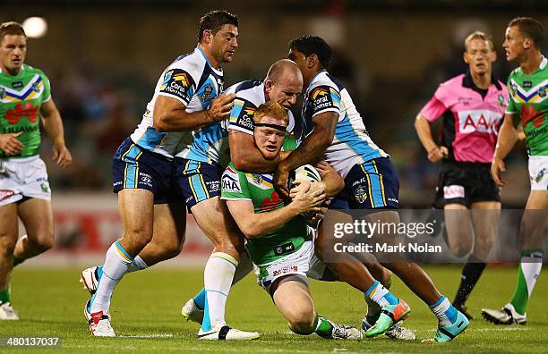 Joel Edwards of the Raiders is tackled high during the round three NRL match between the Canberra Raiders and the Gold Coast Titans at GIO Stadium on...