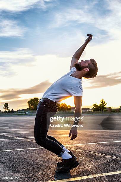 fifties greaser bending backwards in sunset - head back stock pictures, royalty-free photos & images