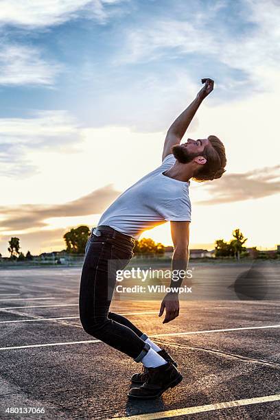 fifties greaser bending backwards in sunset - bending over backwards stock pictures, royalty-free photos & images