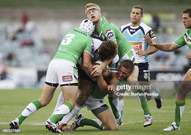 David Taylor of the Titans is tackled during the round three NRL match between the Canberra Raiders and the Gold Coast Titans at GIO Stadium on March...