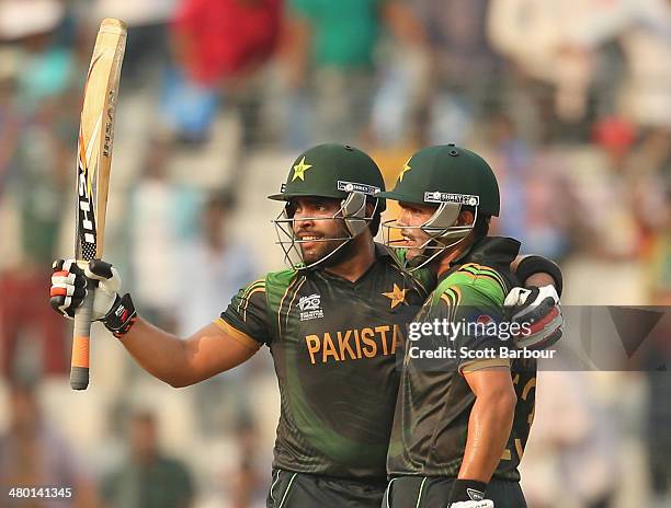 Umar Akmal of Pakistan celebrates after reaching his fifty with Kamran Akmal during the ICC World Twenty20 Bangladesh 2014 match between Australia...