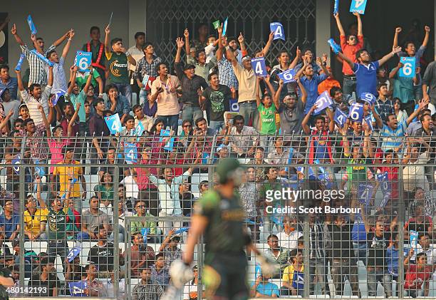 Pakistan fans celebrate after Umar Akmal of Pakistan hit a six during the ICC World Twenty20 Bangladesh 2014 match between Australia and Pakistan at...