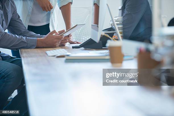 two business people working on a digital tablet. - hand on hip bildbanksfoton och bilder