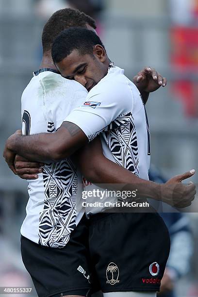 Osea Kolinisau of Fiji is congratulated by team mate Vatemo Ravouvou after scoring a try against New Zealand during the Tokyo Sevens, in the six...
