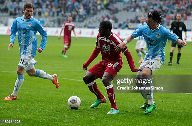 Benjamin Lauth and Markus Schwabl of Muenchen challenges Olivier Occean of Kaiserslautern during the Second Bundesliga match between TSV 1860...