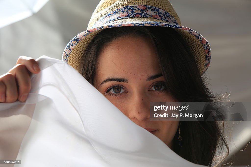 Girl in a hat covering her face