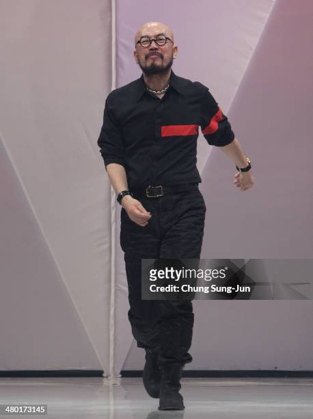 Designer Lie Sang Bong acknowledges the audience on the runway during the Lie Sang Bong show as part of Seoul Fashion Week F/W 2014 on March 23 in...