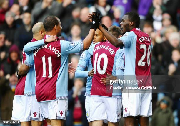 Christian Benteke of Aston Villa celebrates with teammates after scoring the opening goal during the Barclays Premier League match between Aston...