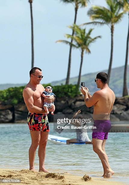 David Furnish is seen at the beach with his son Zachary Furnish-John on February 21, 2011 in Honolulu, Hawaii.