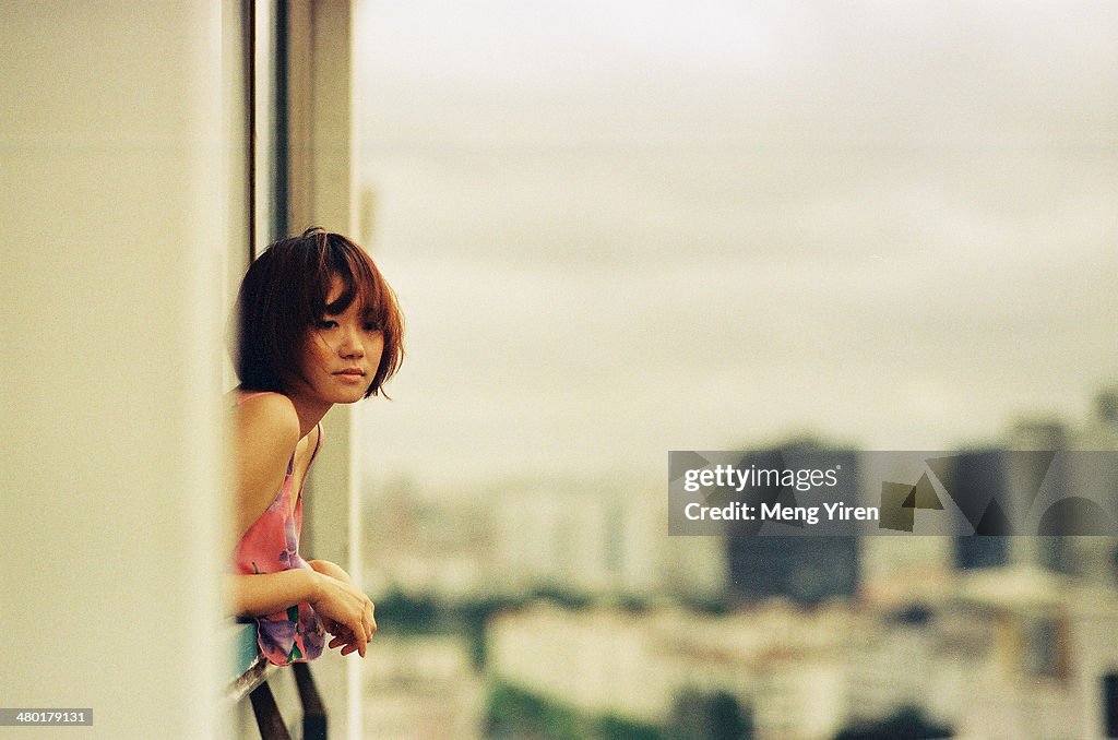 Girl on the balcony with city view