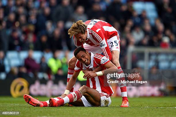 Steven N'Zonzi of Stoke is congratulated by teammate Peter Crouch after scoring his team's third goal during the Barclays Premier League match...