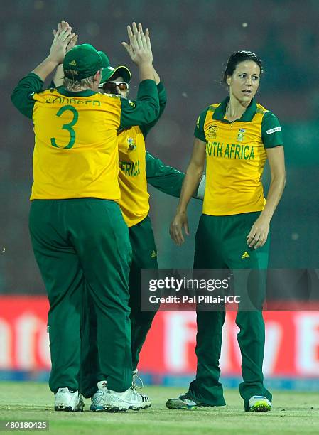 Marizanne Kapp of South Africa celebrates the wicket of Asmavia Iqbal of Pakistan with teammates the ICC Women's World Twenty20 match between South...