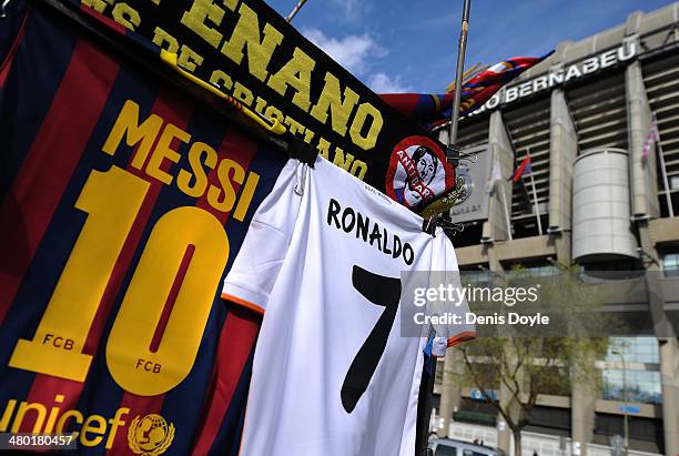 Shirts bearing the names of Lionel Messi of FC Barcelona and Cristiano Ronaldo of Real Madrid CF are see at a merchandise stall prior to the La Liga...