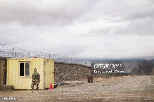 Soldier with the Afghan National Army guards a gate at Forward Operating Base Thunder on March 23, 2014 near Gardez, Afghanistan. Soldiers with the...
