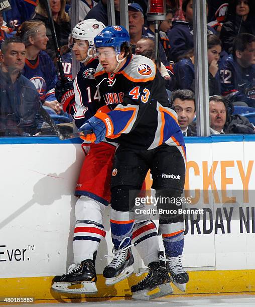 Blake Comeau of the Columbus Blue Jackets is hit into the boards by Mike Halmo of the New York Islanders during the first period at the Nassau...