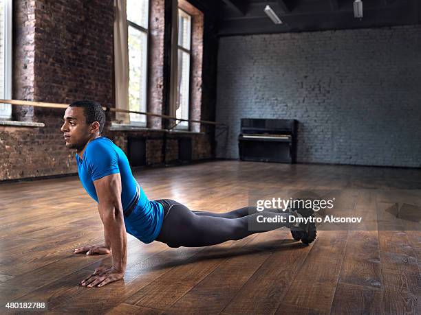 muscular man doing exercises in lofty gym - slimy stock pictures, royalty-free photos & images