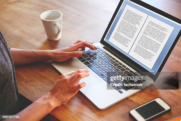 weibliche englische autor schreiben auf dem notebook - hand resting on wood stock-fotos und bilder