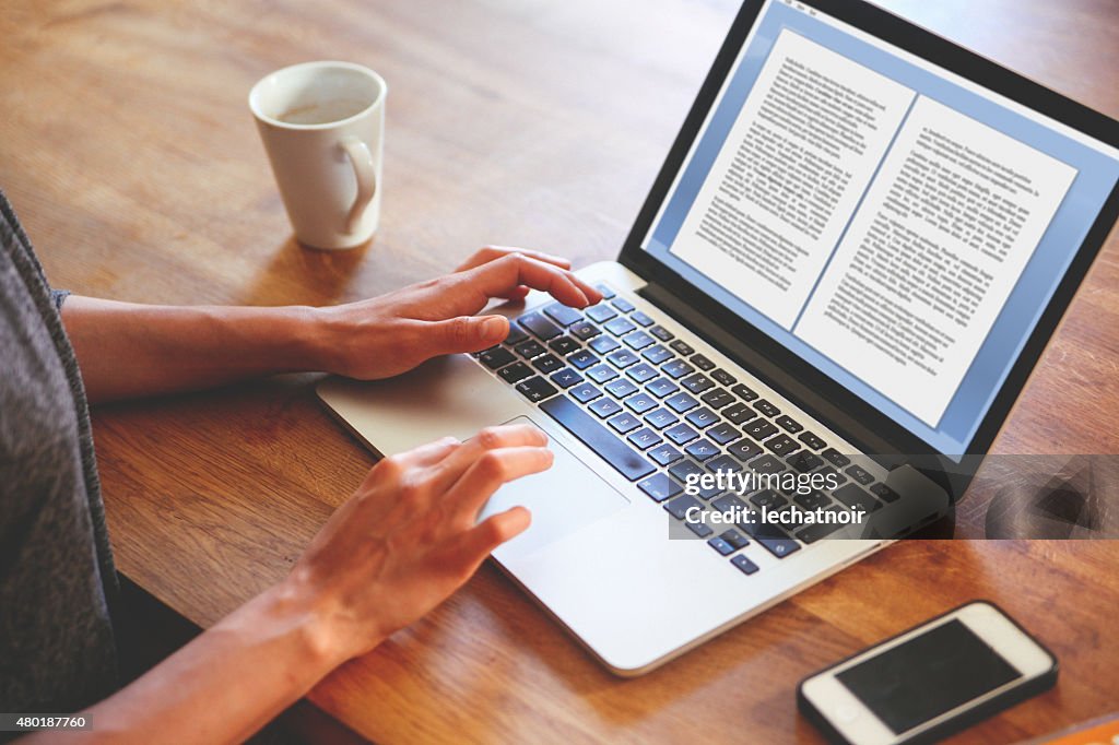 Novelist mujer escribiendo en su computadora portátil