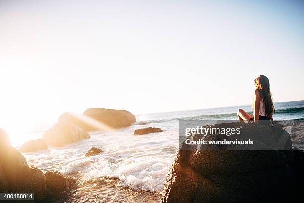 teen girl on rocks at beach on tranquil summer afternoon - girl panoramic stock pictures, royalty-free photos & images