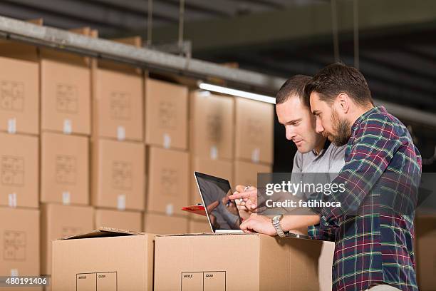 two warehouse worker - business inventory computer stockfoto's en -beelden