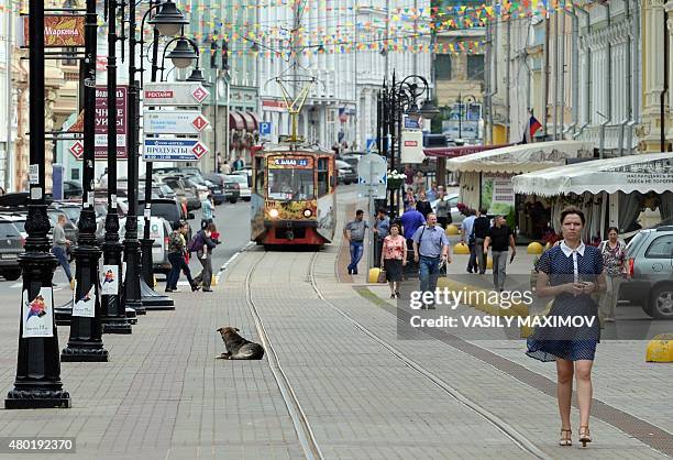 People walk along a street in central Nizhny Novgorod on July 10, 2015. Nizhny Novgorod will host the World Cup 2018 in Russia from June 14 to July...