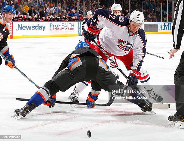 Artem Anisimov of the Columbus Blue Jackets faces off against Johan Sundstrom of the New York Islanders at Nassau Veterans Memorial Coliseum on March...