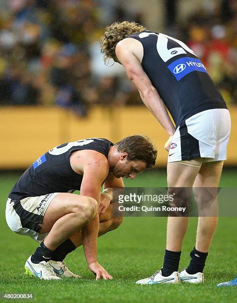 Lachie Henderson and Nick Holman of the Blues look dejected after losing the round 15 AFL match between the Richmond Tigers and the Carlton Blues at...