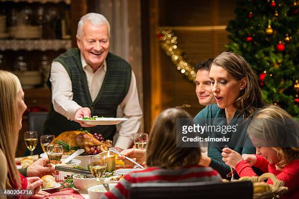 family having christmas dinner - cooked turkey white plate stockfoto's en -beelden