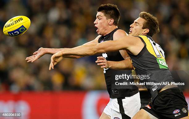 Matthew Kreuzer of the Blues and Shaun Hampson of the Tigers compete for the ball during the 2015 AFL round 15 match between the Richmond Tigers and...