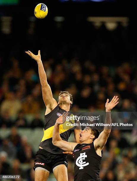 Shaun Hampson of the Tigers and Matthew Kreuzer of the Blues compete in a ruck contest during the 2015 AFL round 15 match between the Richmond Tigers...