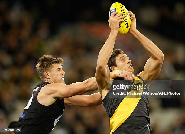 Cameron Wood of the Blues and Shaun Hampson of the Tigers compete for the ball during the 2015 AFL round 15 match between the Richmond Tigers and the...
