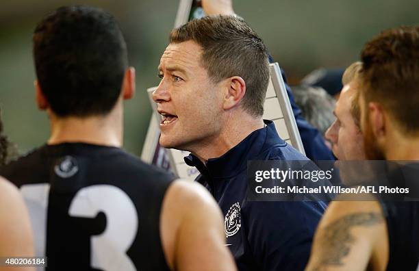 John Barker, Interim Coach of the Blues addresses his players during the 2015 AFL round 15 match between the Richmond Tigers and the Carlton Blues at...