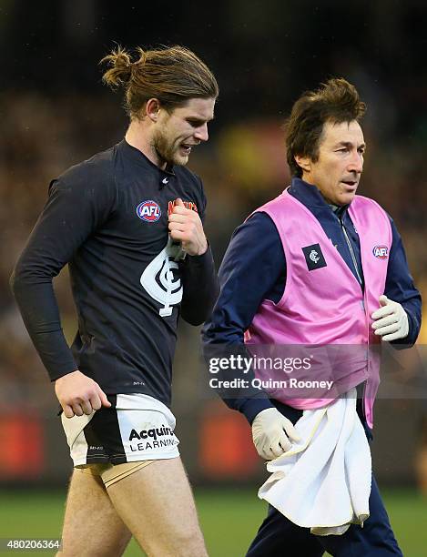 Bryce Gibbs of the Blues comes from the ground with an injury during the round 15 AFL match between the Richmond Tigers and the Carlton Blues at...