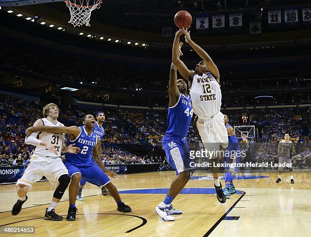 Wichita State Shockers forward Darius Carter goes for a basket over Kentucky Wildcats center Dakari Johnson during the third round of the NCAA...