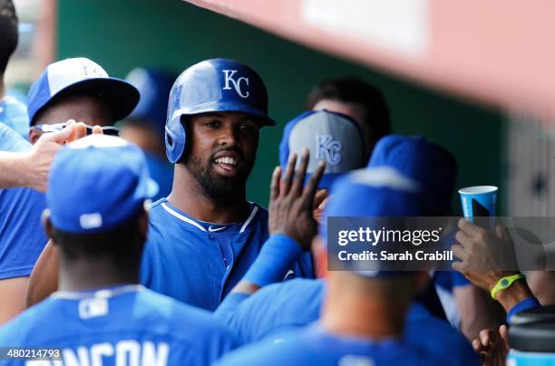 Carlos Peguero of the Kansas City Royal celebrates in the dugout after scoring in the second inning during a game against the San Francisco Giants at...