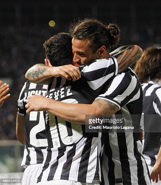 Carlos Tevez and Pablo Osvaldo of Juventus celebrate the opening goal during the Serie A match between Calcio Catania and Juventus at Stadio Angelo...