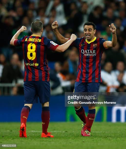 Xavi of Barcelona celebrates victory with Andres Iniesta after the La Liga match between Real Madrid CF and FC Barcelona at the Bernabeu on March 23,...