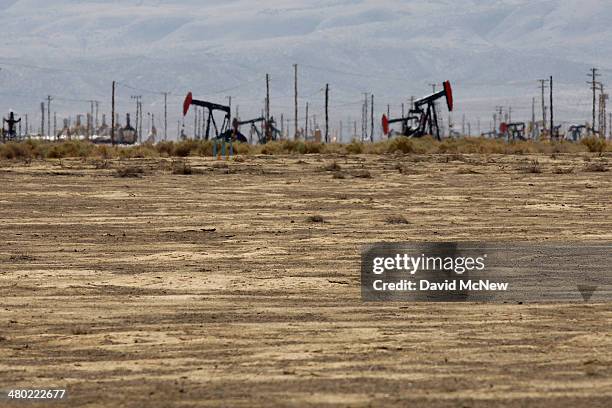 Old farmland lies unused next to an oil field over the Monterey Shale formation where gas and oil extraction using hydraulic fracturing, or fracking,...