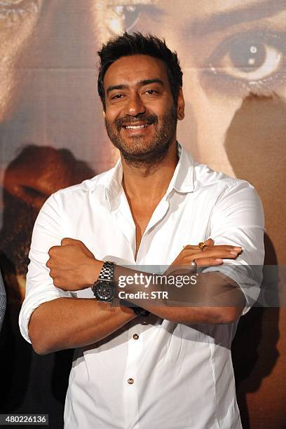 Indian Bollywood actor Ajay Devgn poses during the poster and song launch of the upcoming Hindi film 'Drishyam' directed by Nishikant Kamat in Mumbai...