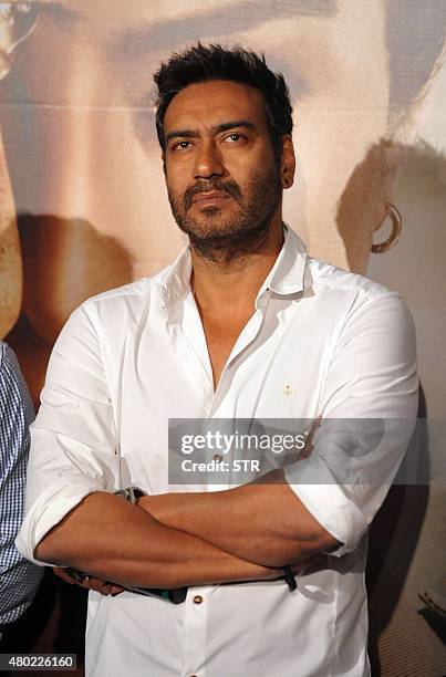 Indian Bollywood actor Ajay Devgn poses during the poster and song launch of the upcoming Hindi film 'Drishyam' directed by Nishikant Kamat in Mumbai...