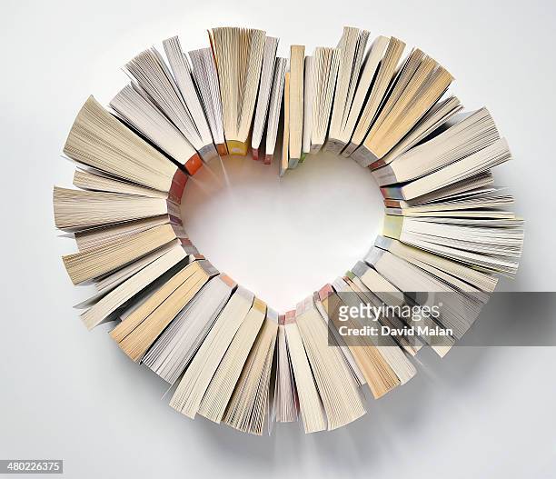 book spines forming a heart shape - love books stock-fotos und bilder