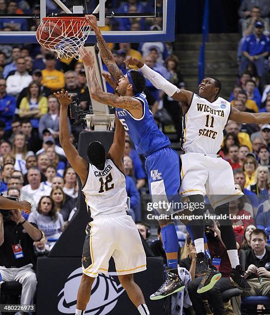 Kentucky Wildcats forward Willie Cauley-Stein goes baseline for a dunk over Wichita State Shockers forward Darius Carter during the third round of...