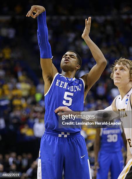 Kentucky Wildcats guard Andrew Harrison grimaces as he misfires on the second of two free throws in the final seconds of the third round of the NCAA...