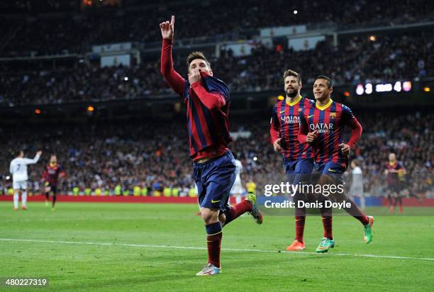 Lionel Messi of Barcelona celebrates scoring his team's fourth goal during the La Liga match between Real Madrid CF and FC Barcelona at the Bernabeu...