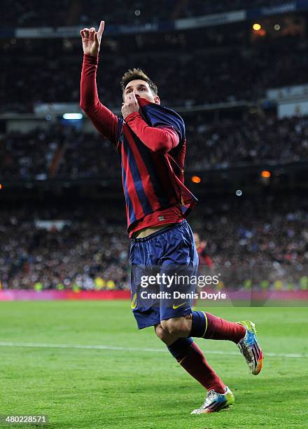 Lionel Messi of Barcelona celebrates scoring his team's fourth goal during the La Liga match between Real Madrid CF and FC Barcelona at the Bernabeu...