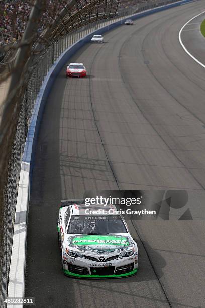 Kyle Busch, driver of the Interstate Batteries Toyota, races during the NASCAR Sprint Cup Series Auto Club 400 at Auto Club Speedway on March 23,...