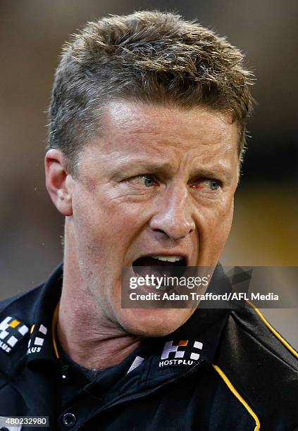 Damien Hardwick, Senior Coach of the Tigers addresses his players during the 2015 AFL round 15 match between the Richmond Tigers and the Carlton...