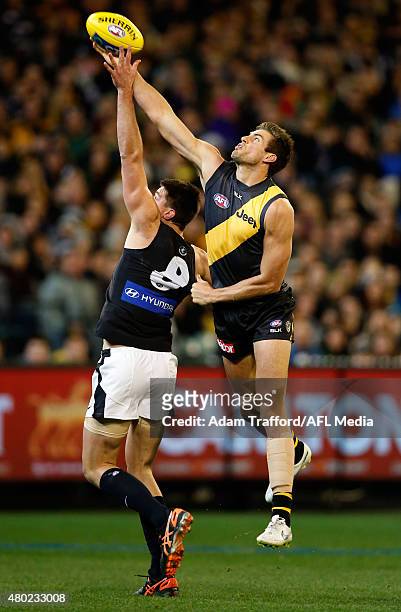 Matthew Kreuzer of the Blues and Shaun Hampson of the Tigers compete in a ruck contest during the 2015 AFL round 15 match between the Richmond Tigers...